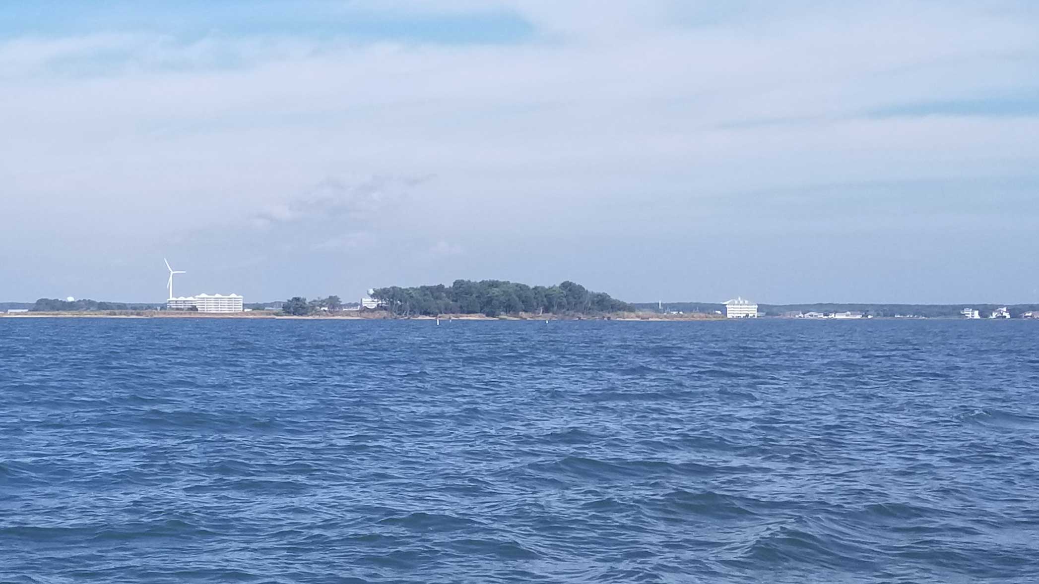 Wind generator near shore. Believed to be Crisfield on the Chesapeake Bay, USA.